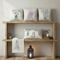 Decorative pillows and towel on a wooden shelf with a lantern and books.